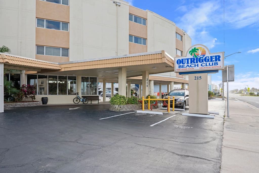 Sandy beach shoreline with gentle waves and open ocean horizon.